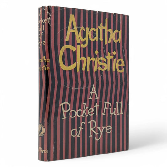 Front Cover: A first edition of A Pocket Full of Rye by Agatha Christie, published by Collins Crime Club in 1953. The dust jacket has a black and red striped design with bold yellow and white lettering.